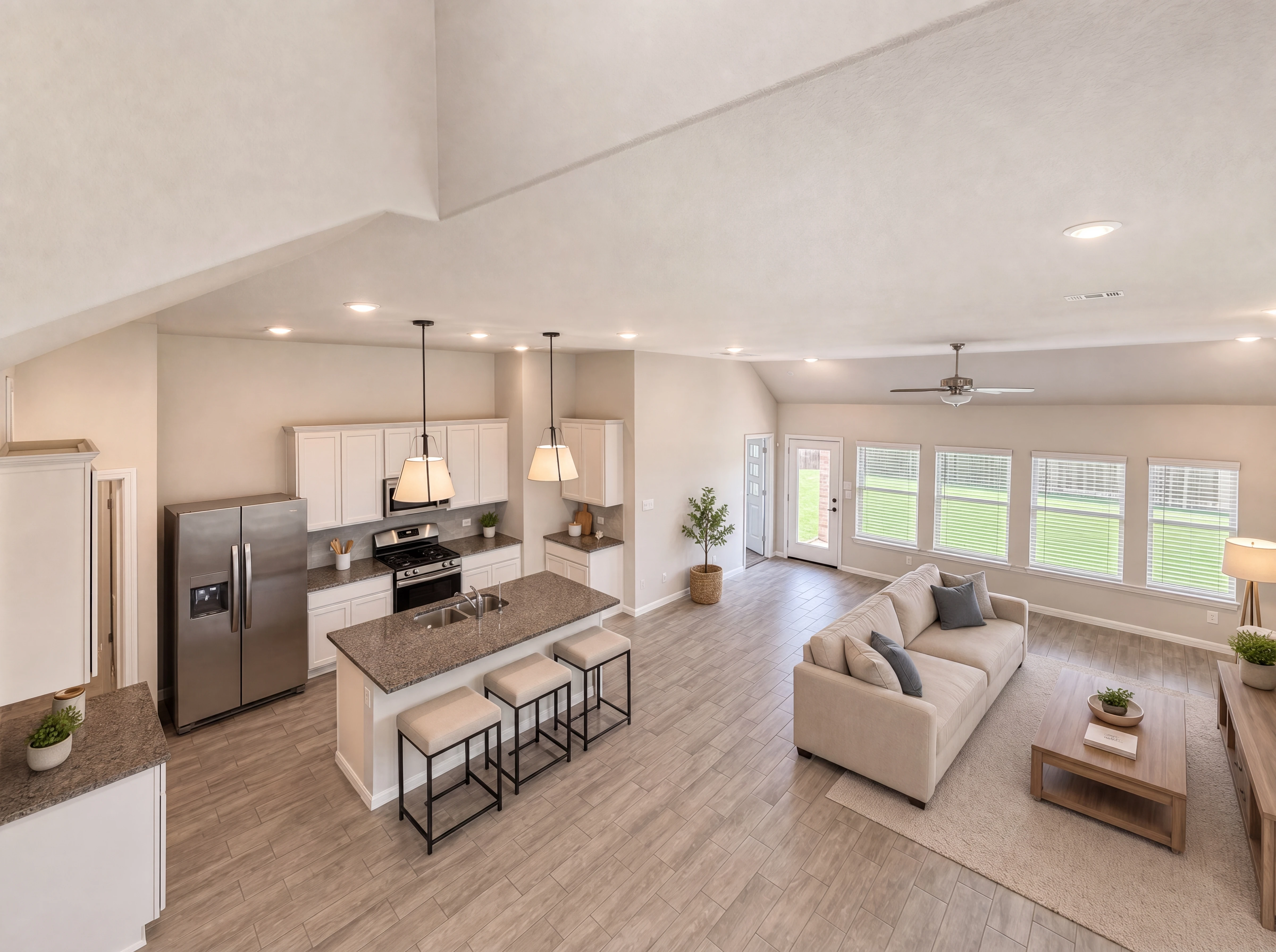 View from upstairs landing into great room and kitchen